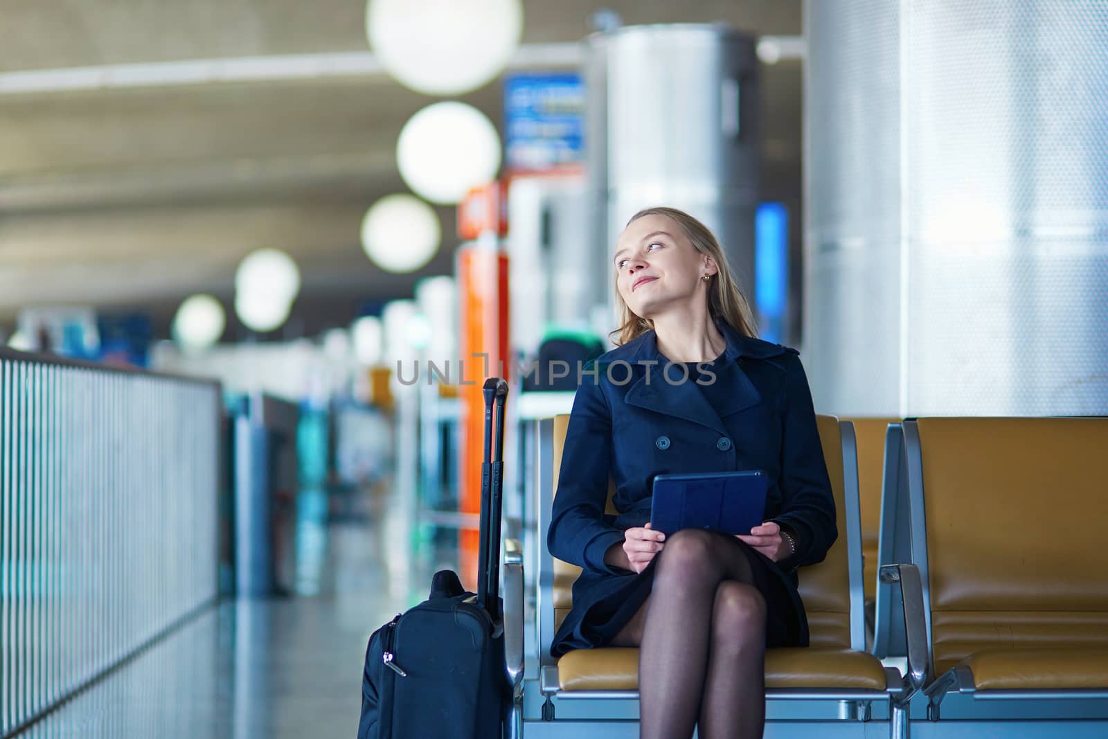 Young female traveler in international airport by jaspe