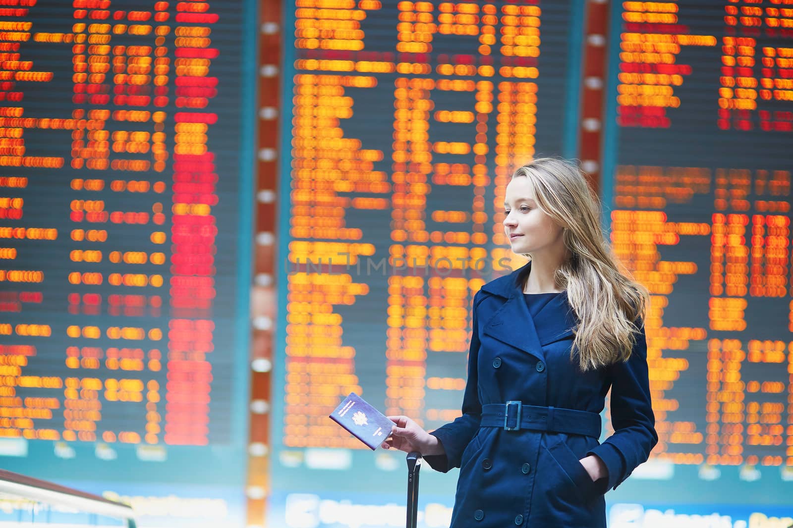 Young female traveler in international airport by jaspe