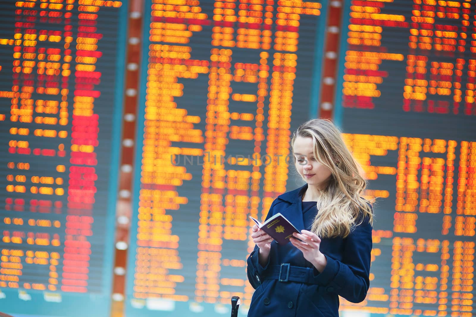 Young female traveler in international airport by jaspe