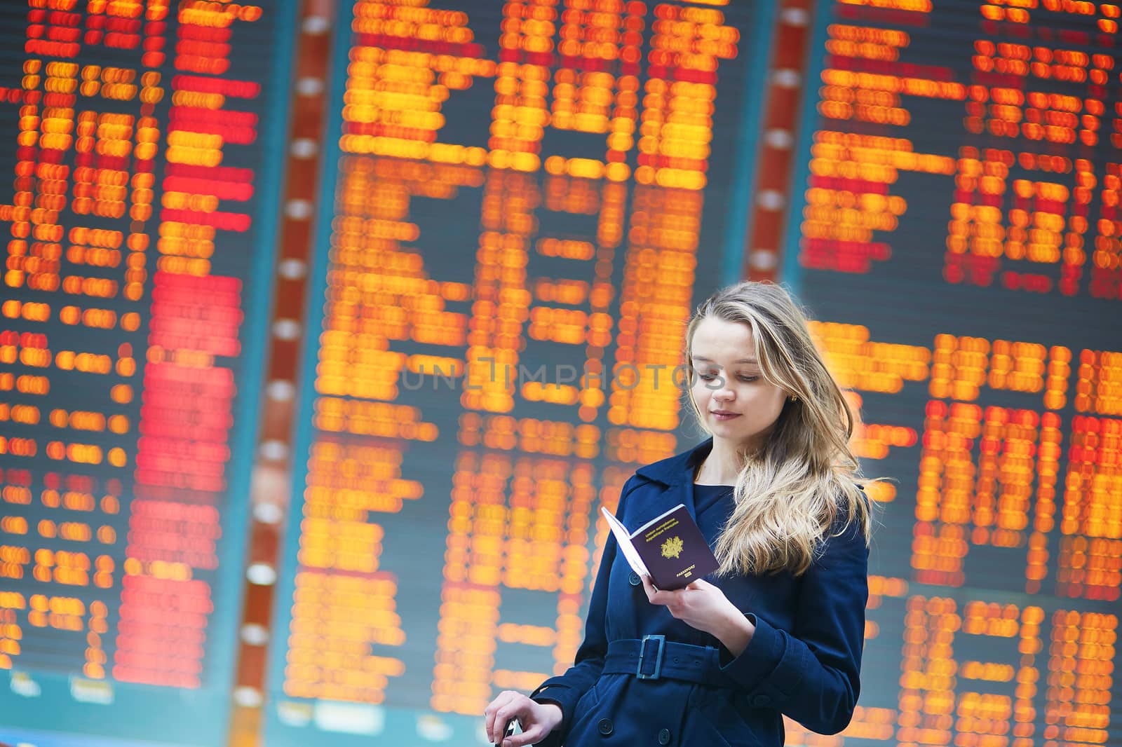 Young female traveler in international airport by jaspe