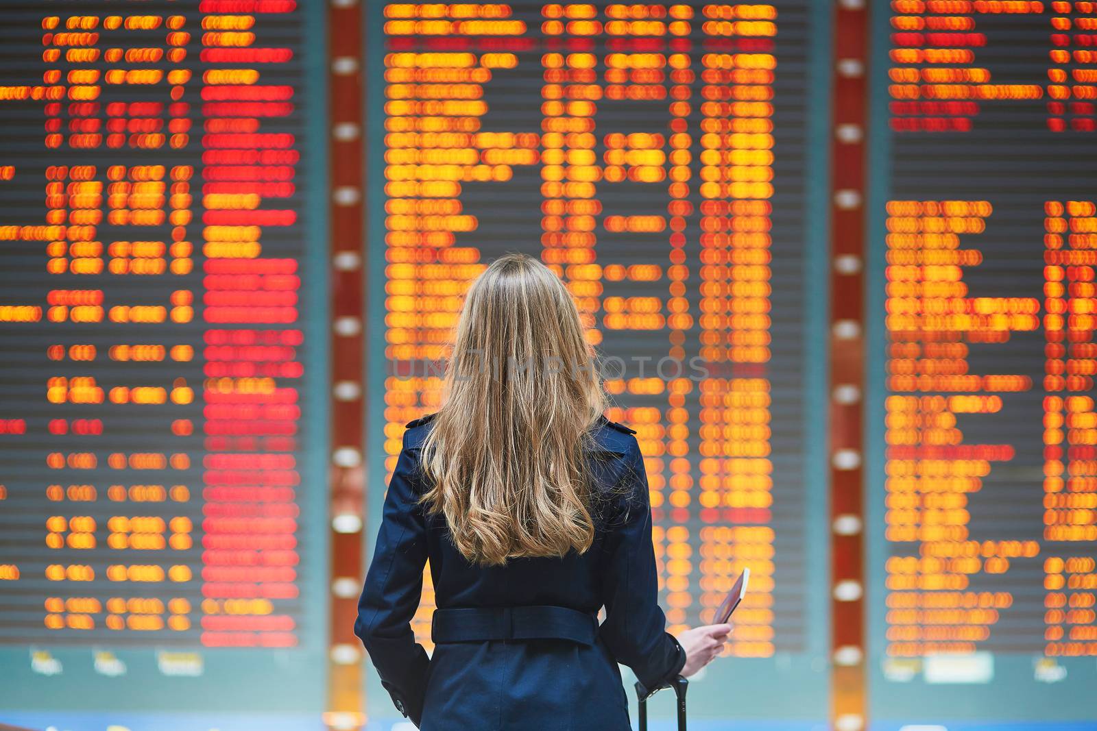 Young female traveler in international airport by jaspe