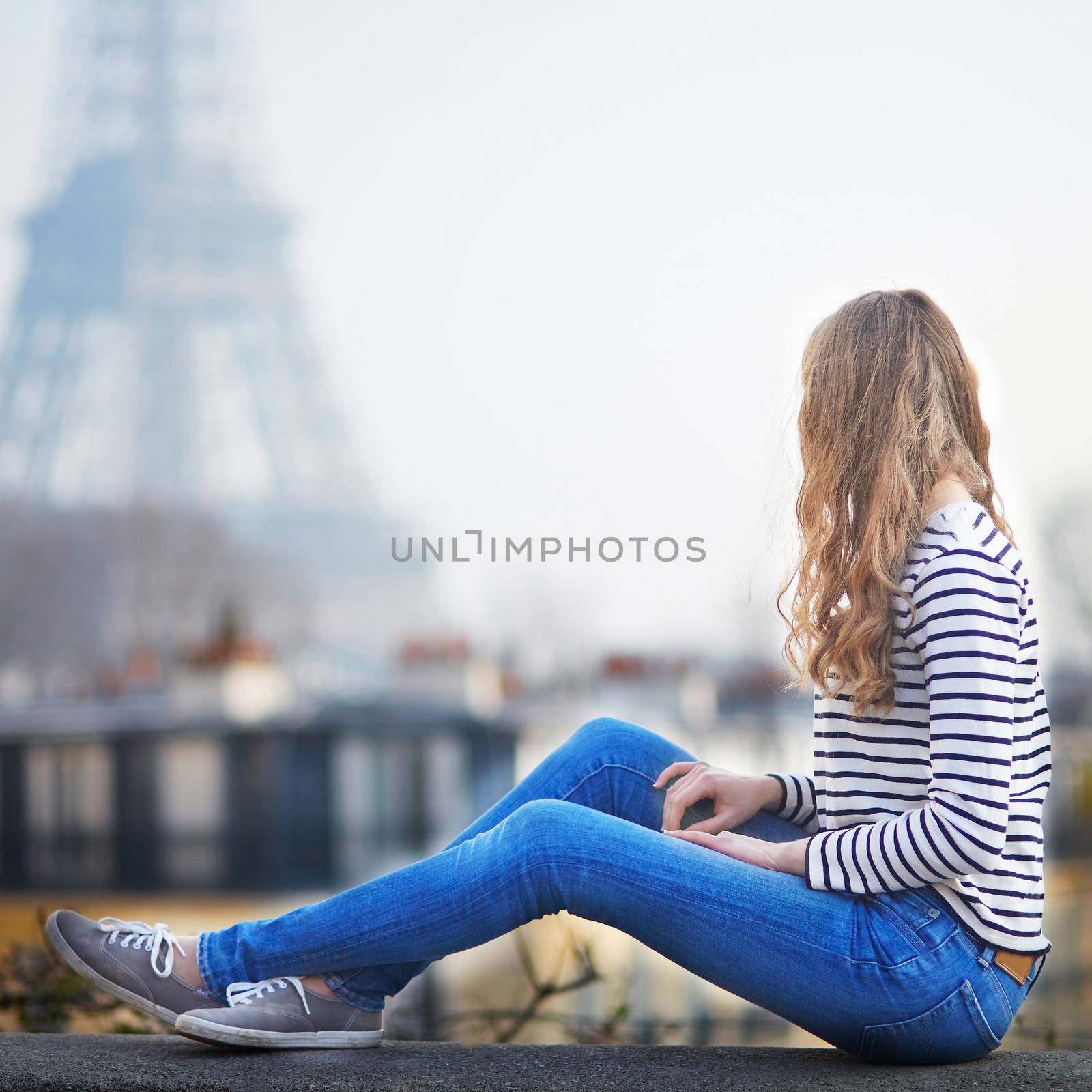 Happy young woman in Paris, near the Eiffel tower by jaspe