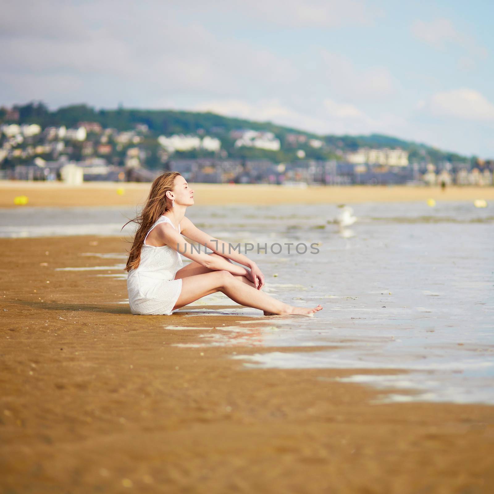 Young woman enjoying her vacation by ocean or sea by jaspe