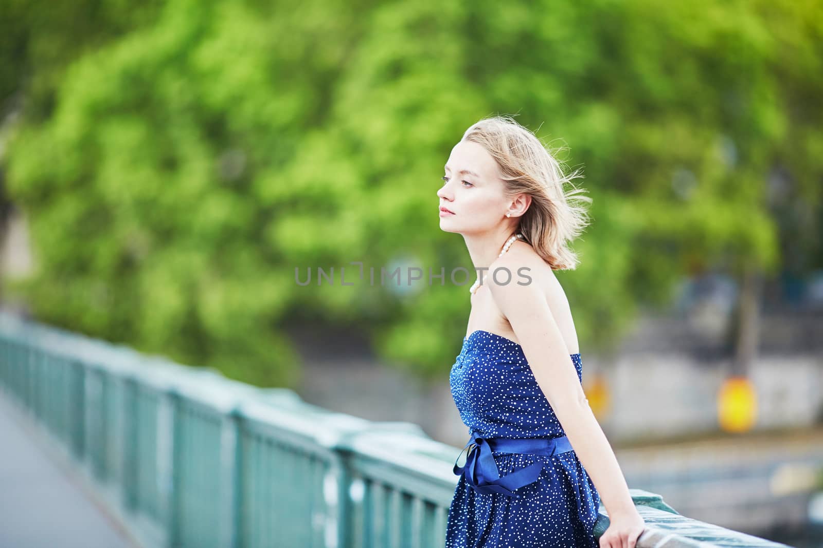 Beautiful young elegant French woman in Paris outdoors