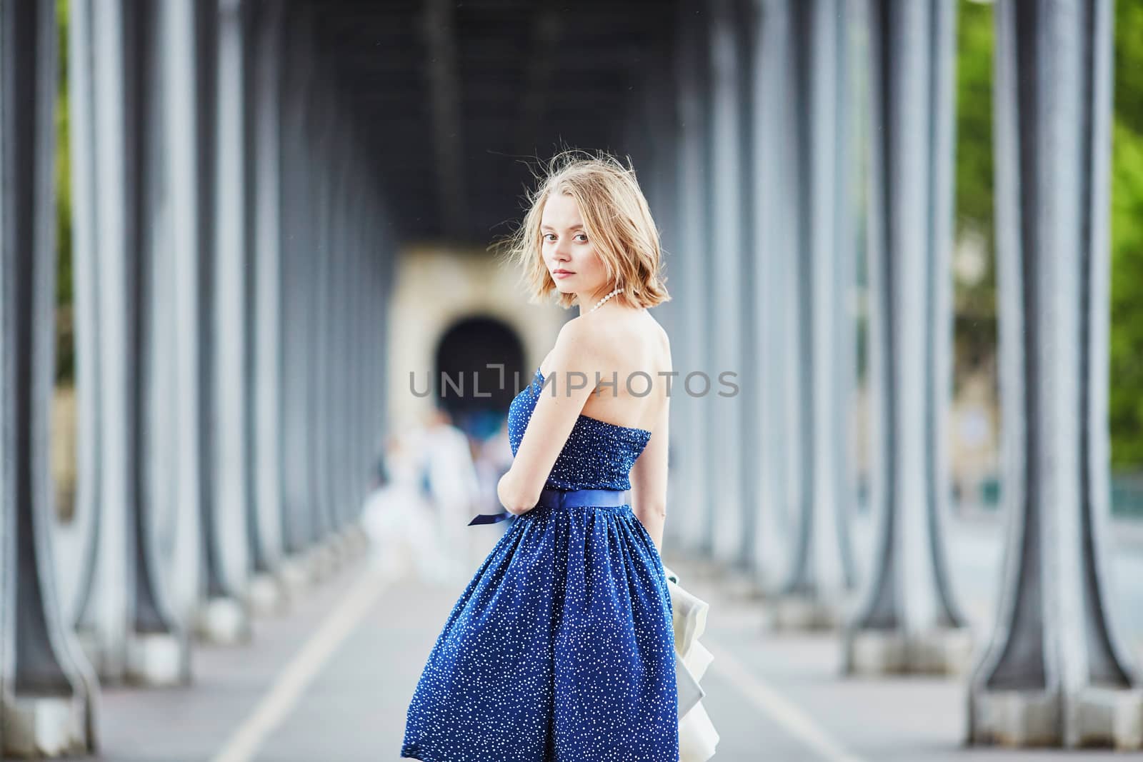 Beautiful young elegant French woman in Paris outdoors