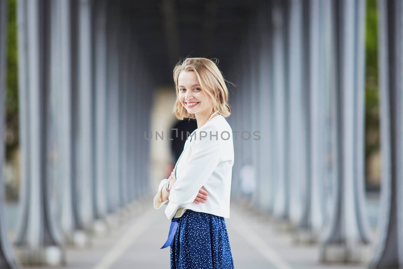 Beautiful young elegant French woman in Paris outdoors