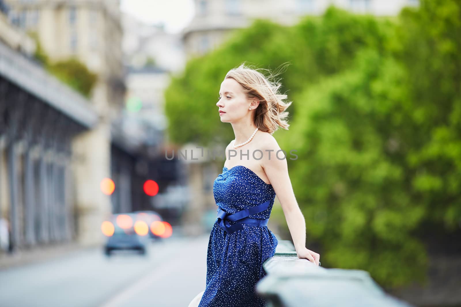 Beautiful young elegant French woman in Paris outdoors