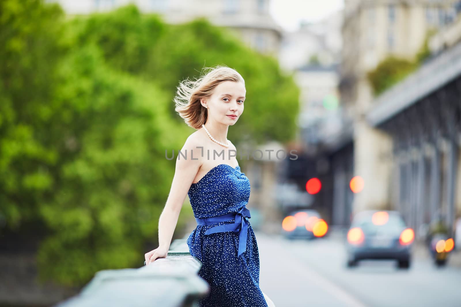 Beautiful young elegant French woman in Paris outdoors