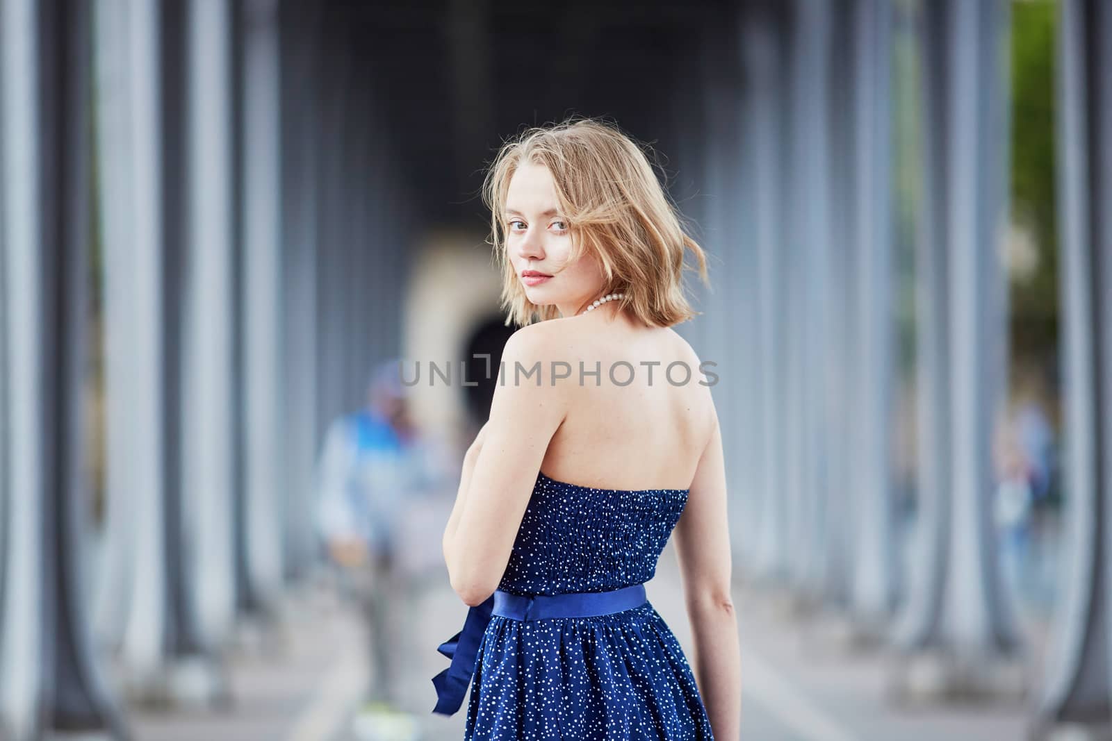 Beautiful young elegant French woman in Paris outdoors