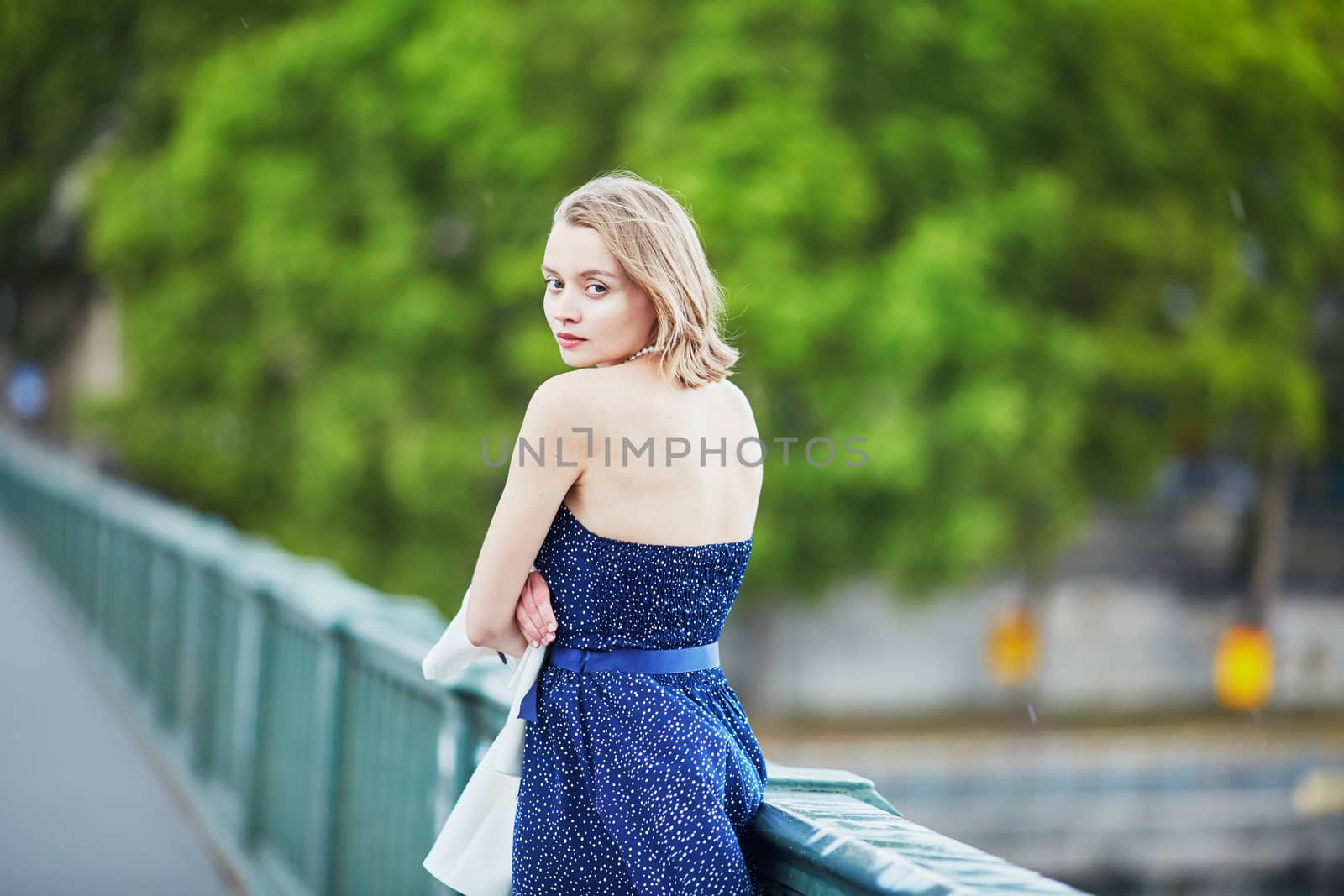 Beautiful young elegant French woman in Paris outdoors