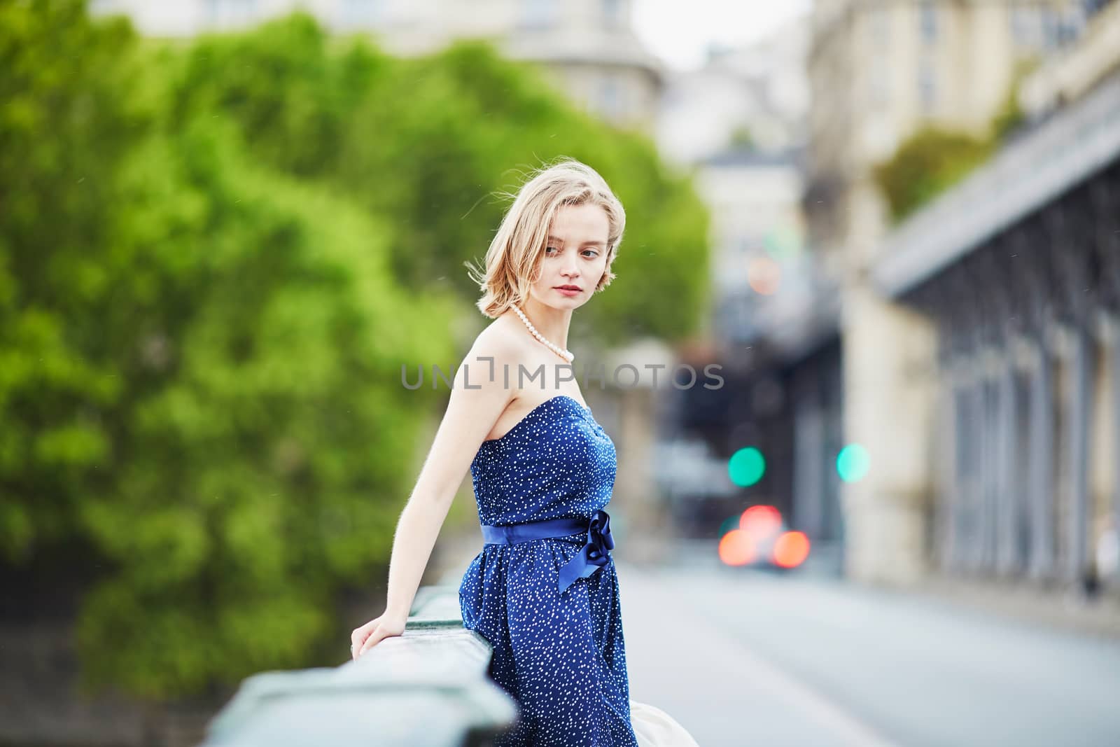 Beautiful young elegant French woman in Paris outdoors