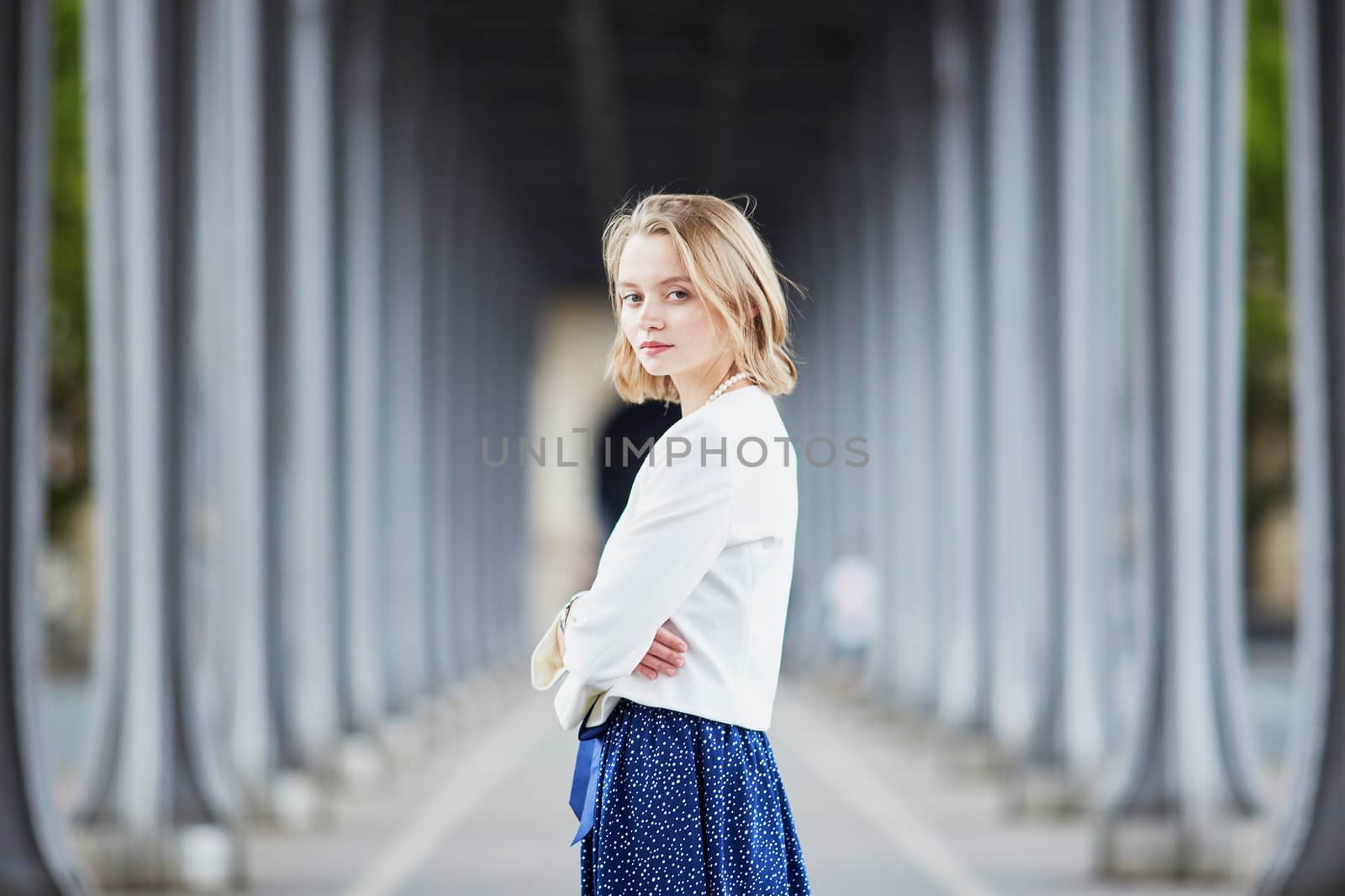 Beautiful young elegant French woman in Paris outdoors