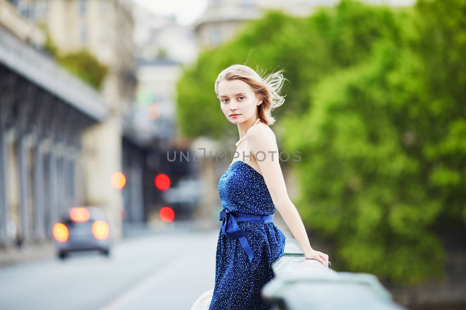 Beautiful young elegant French woman in Paris outdoors