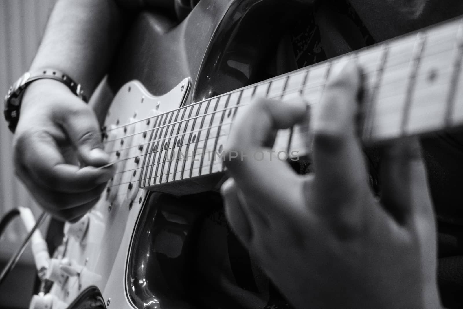 A young child playing an electric guitar