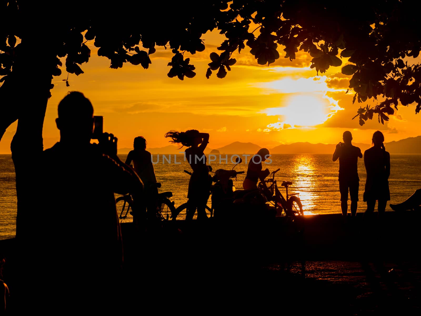 People at Sunset on the beach of Ao Nang in Krabi Thailand