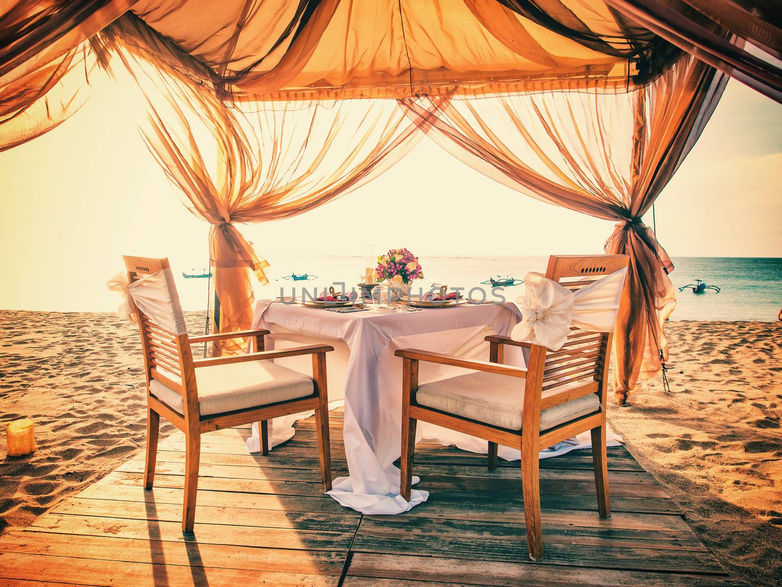Romantic dinner setting on the beach by Netfalls