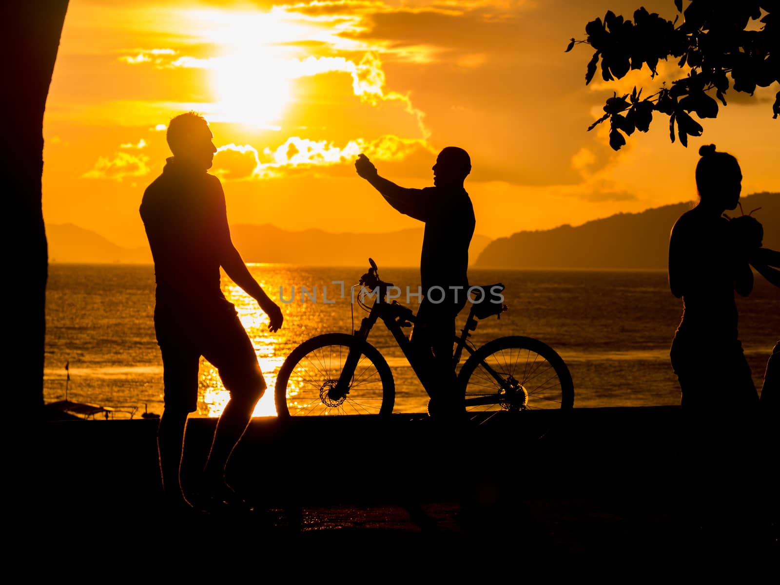 People at Sunset on the beach of Ao Nang in Krabi Thailand