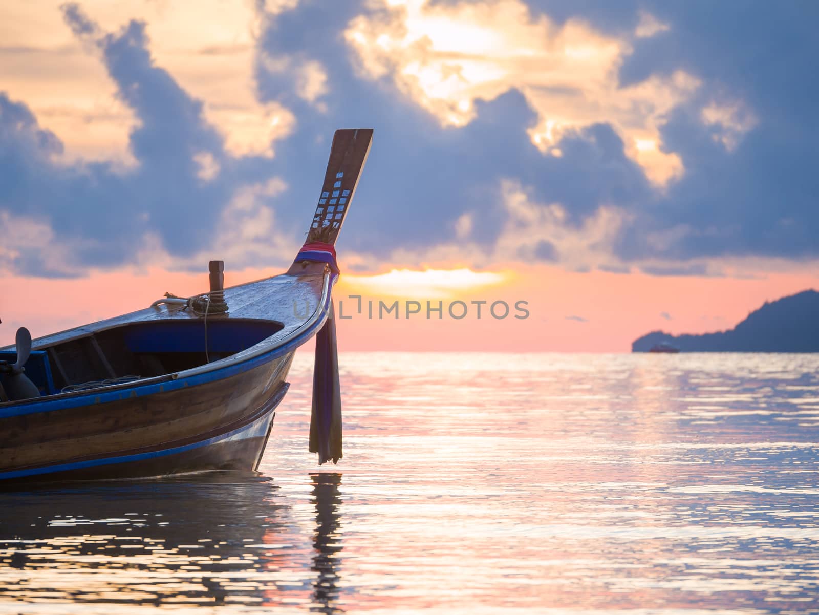 Long tailed boat  Ruea Hang Yao at sunrise in Phuket Thailand