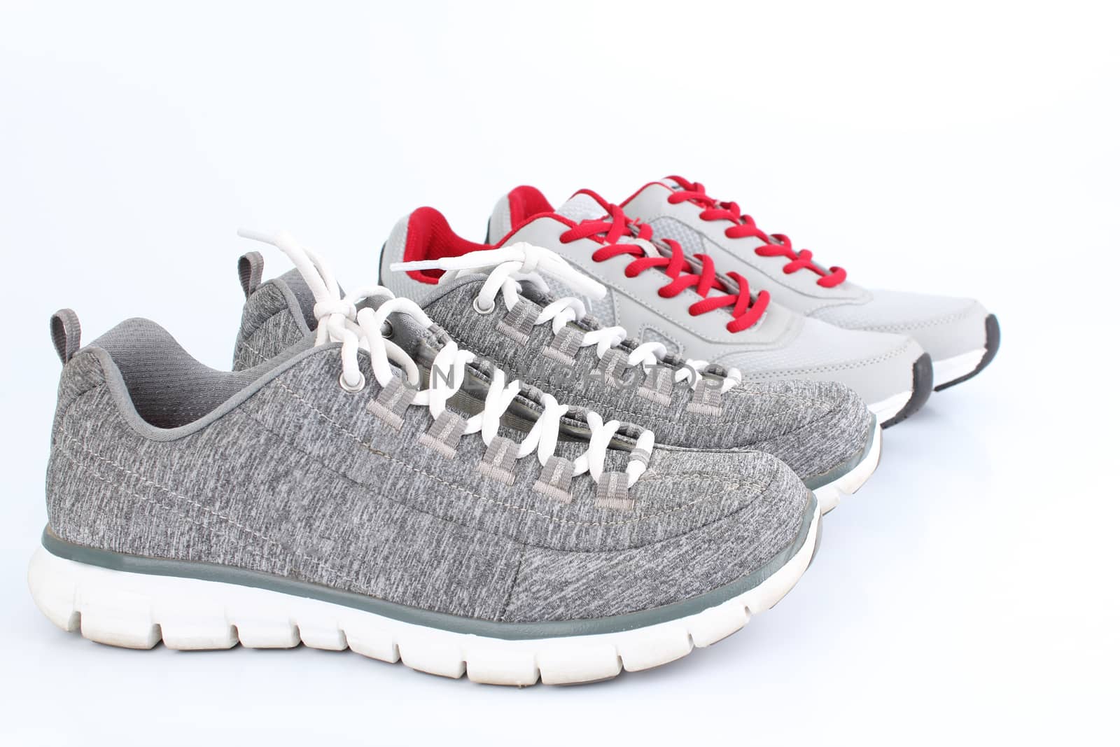 2 gray sneakers pair side by side. On a white background