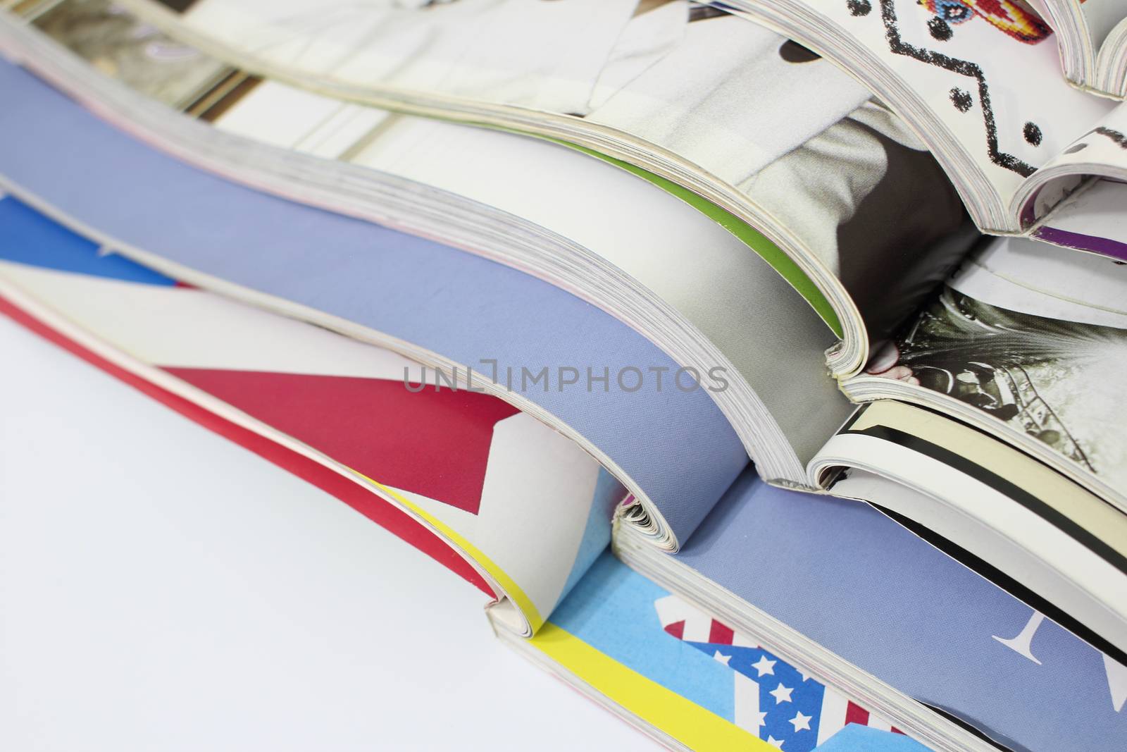 stack of magazines on white background by Mizkit