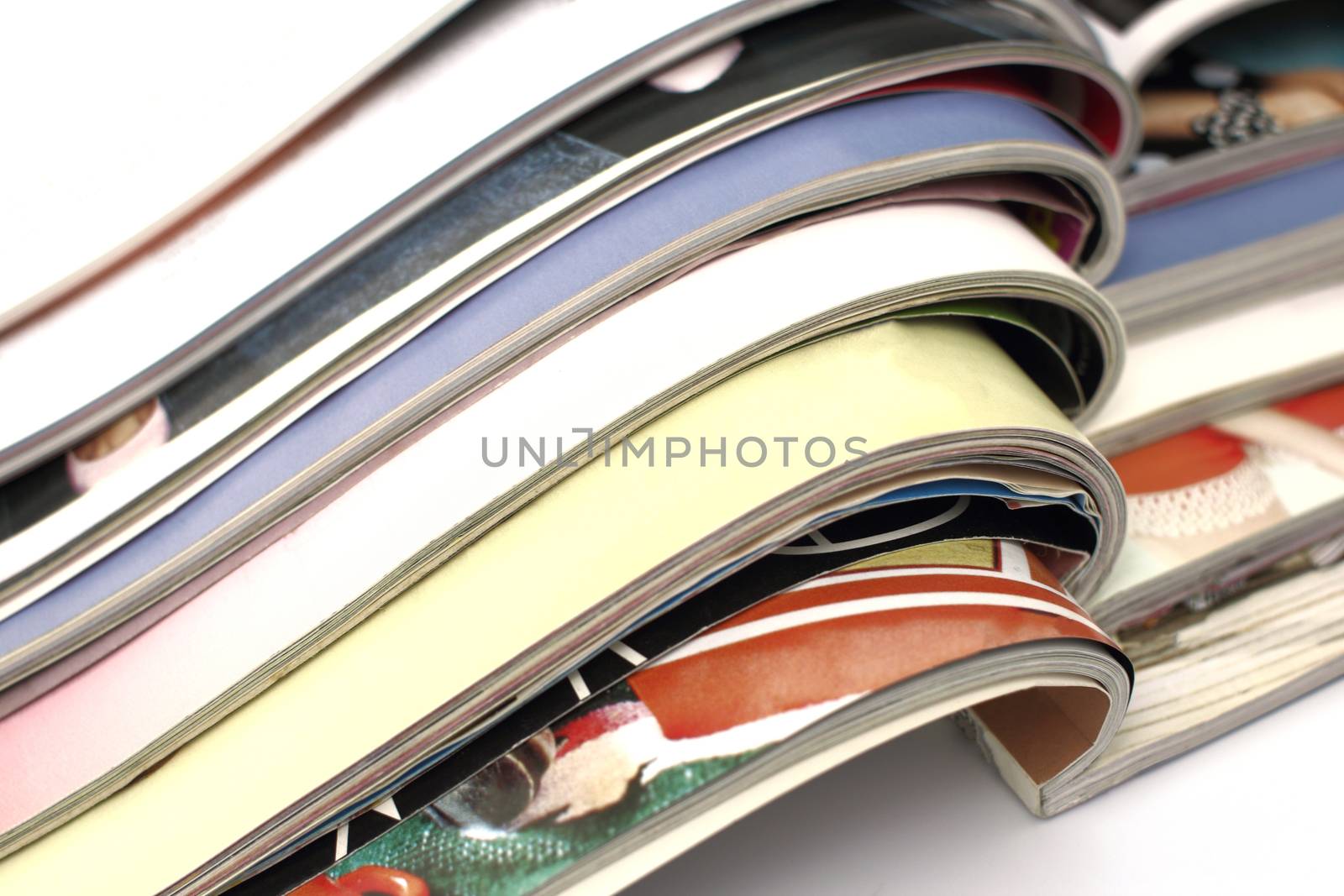 stack of magazines on white background by Mizkit