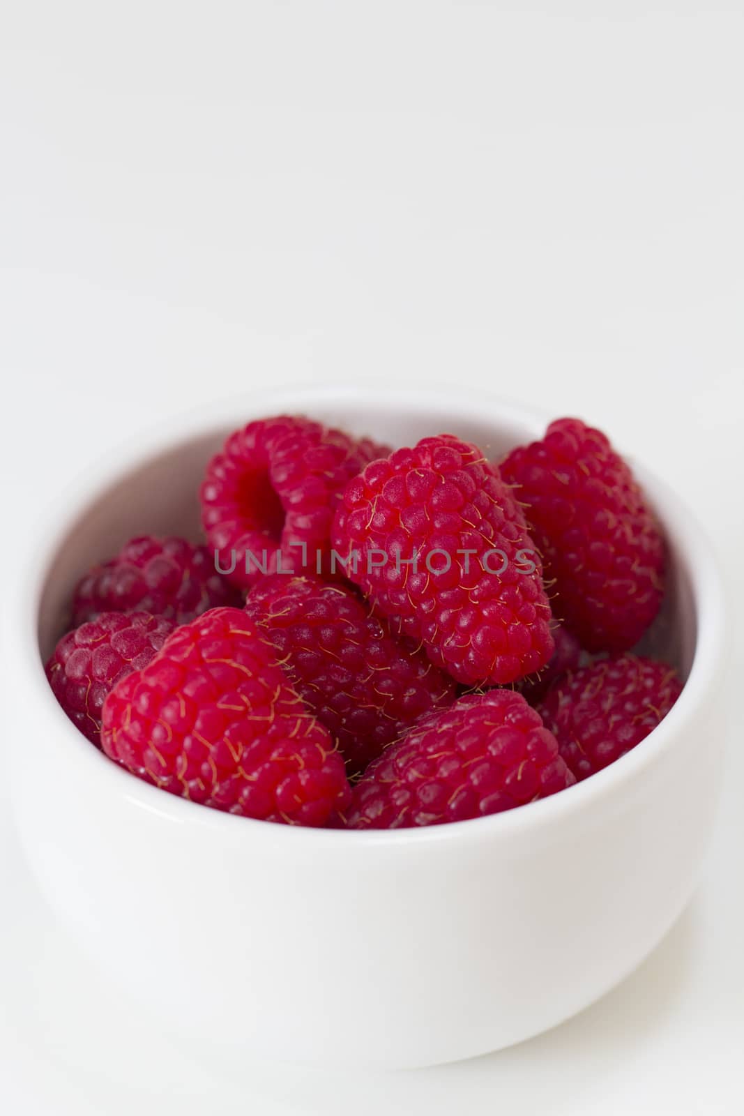 Raspberries, Rubus idaeus, in a white bowl