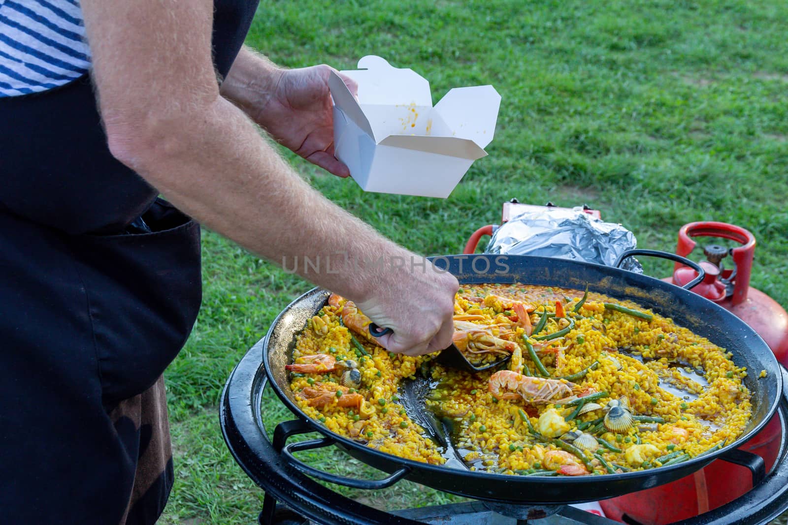 A large pan of seafood paella outdoors by magicbones