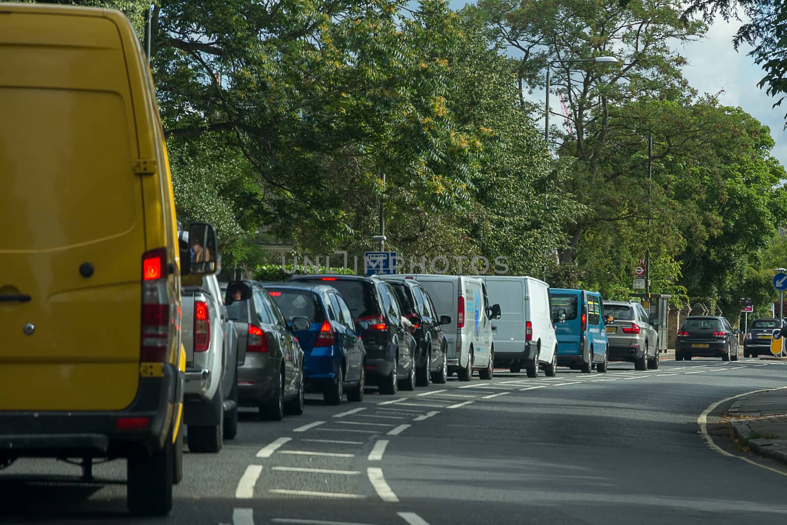 Cars and vans queueing in heavy traffic on a busy London road