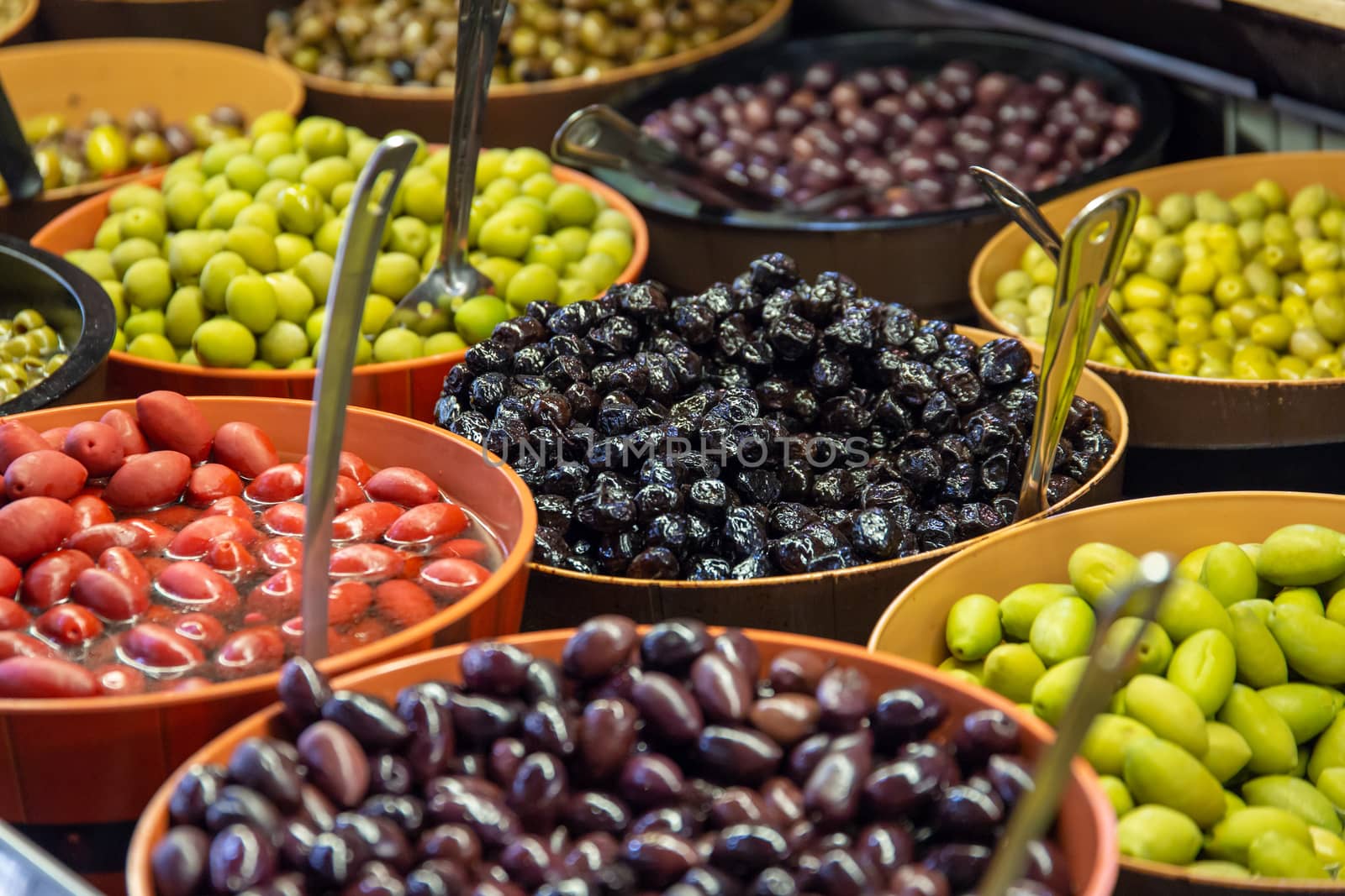 Bowls of green and black olives on display on a stall in St Lawrence Market, Toronto, Canada