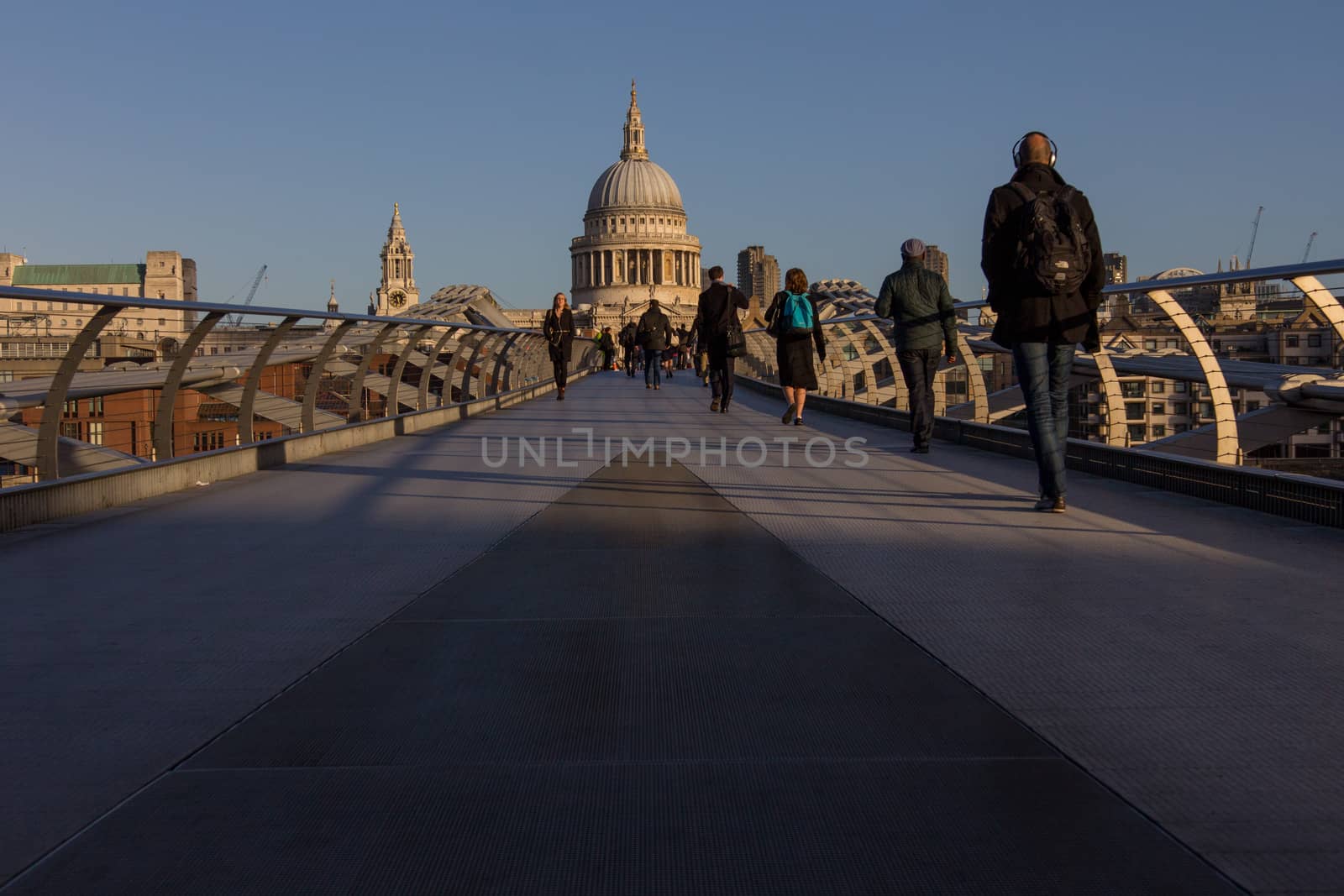 Commuters walking on the Millennium footbridge towards St Paul's Cathedral, London