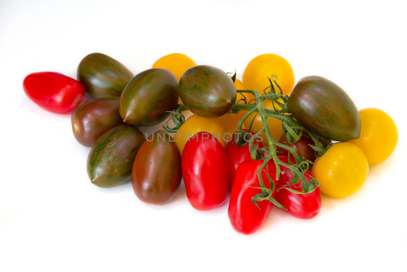 Close up assortment of red, yellow and green tomatoes by magicbones