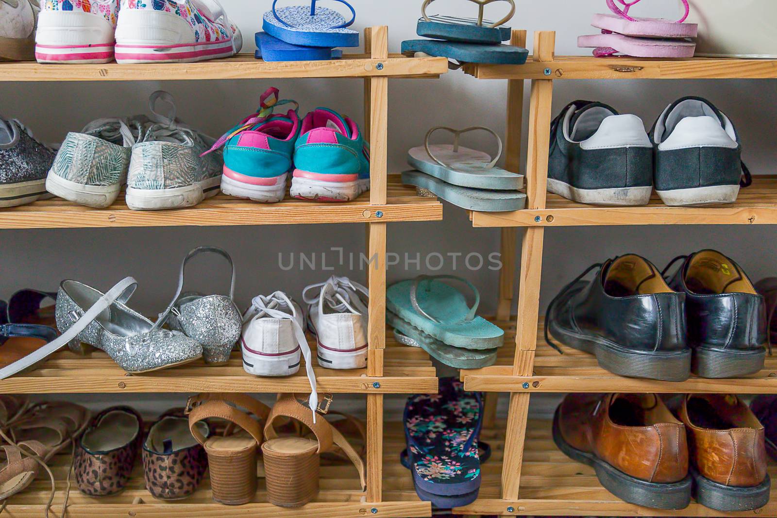 Wooden shoe racjk with assorted family footwear