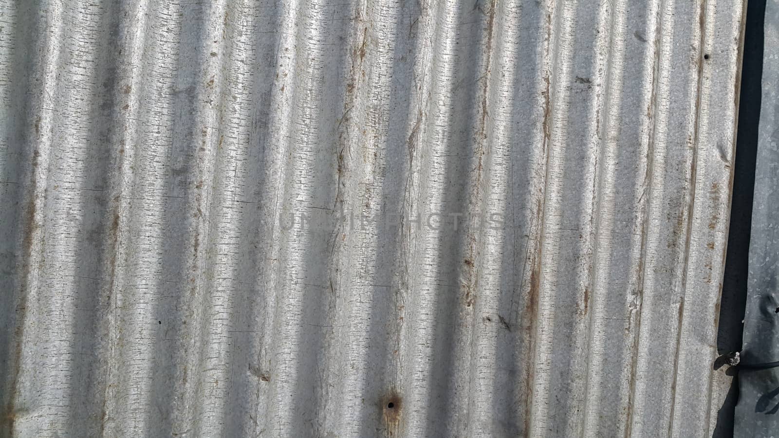 Silver corrugated metal sheet texture background  by Photochowk