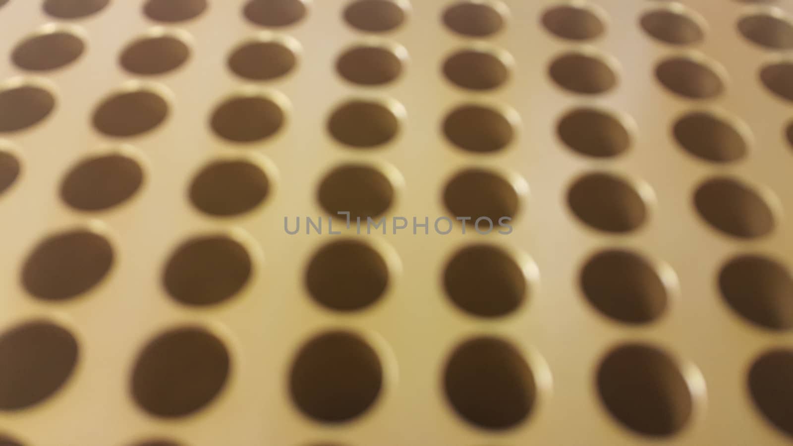 Close up view of holes in golden micro pipette box for scientific research laboratory: Science equipment