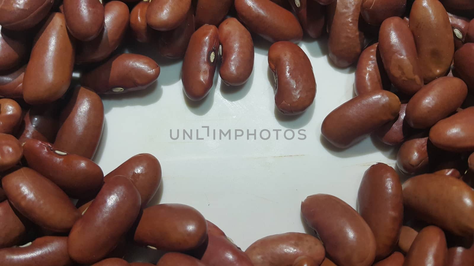 Kidenry beans: Closeup view of uncooked red kidney beans by Photochowk