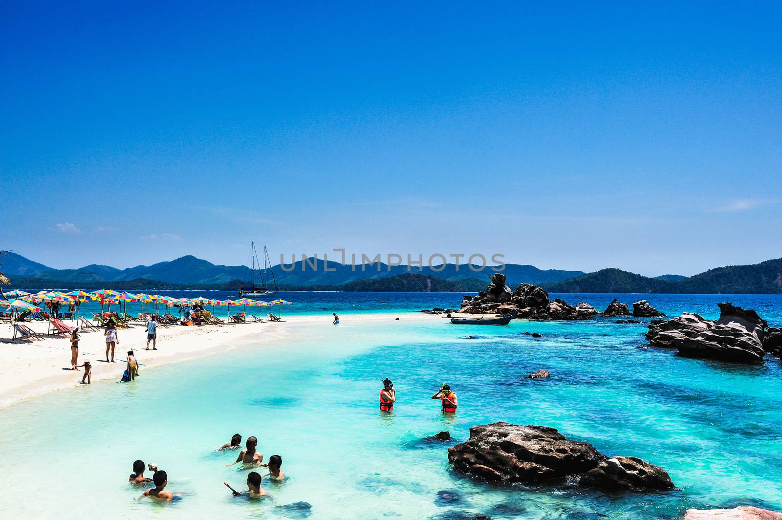 Tourists Relax on the beach in Phuket, Thailand