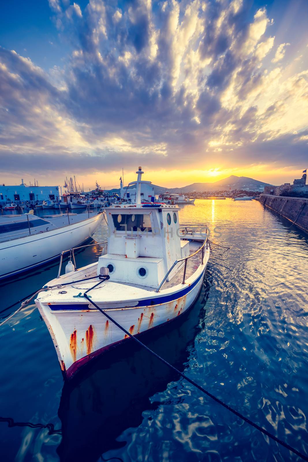 Fishing boat in port of Naousa on sunset. Paros lsland, Greece by dimol