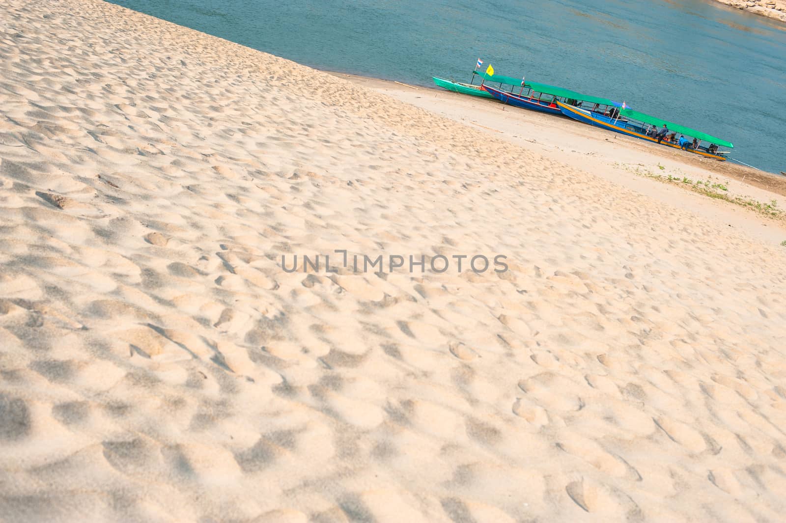 Longtail boat, Berth at sand Sam Pan Bok Grand Canyon in Maekhong river, Northeast of Thailand.