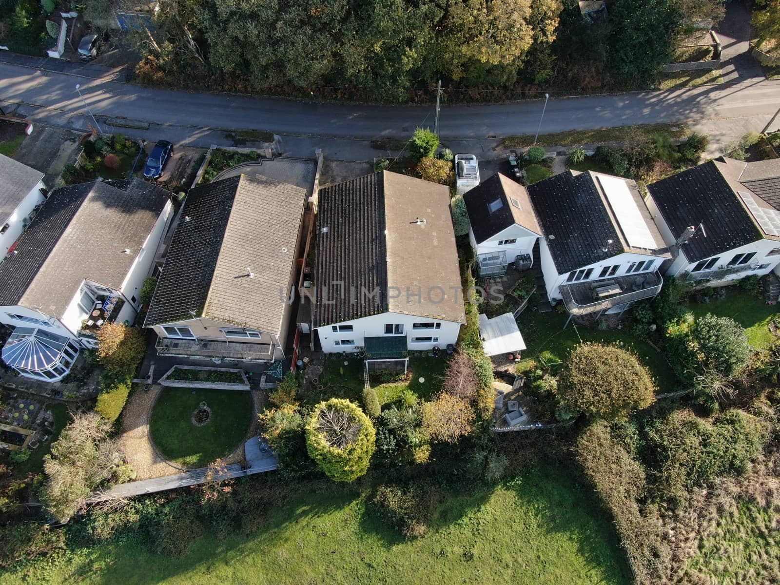 aerial view of suburban detached houses and gardens in a semi-rural area
