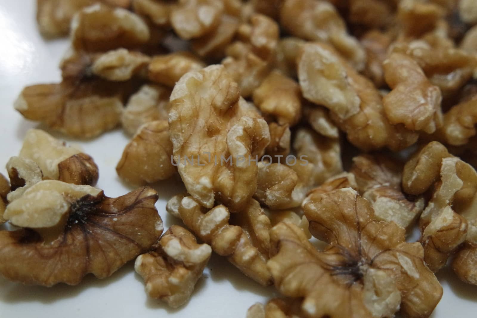 Close-up top view of peeled walnut on a white background. peeled walnut without shell ready to eat dry fruit.