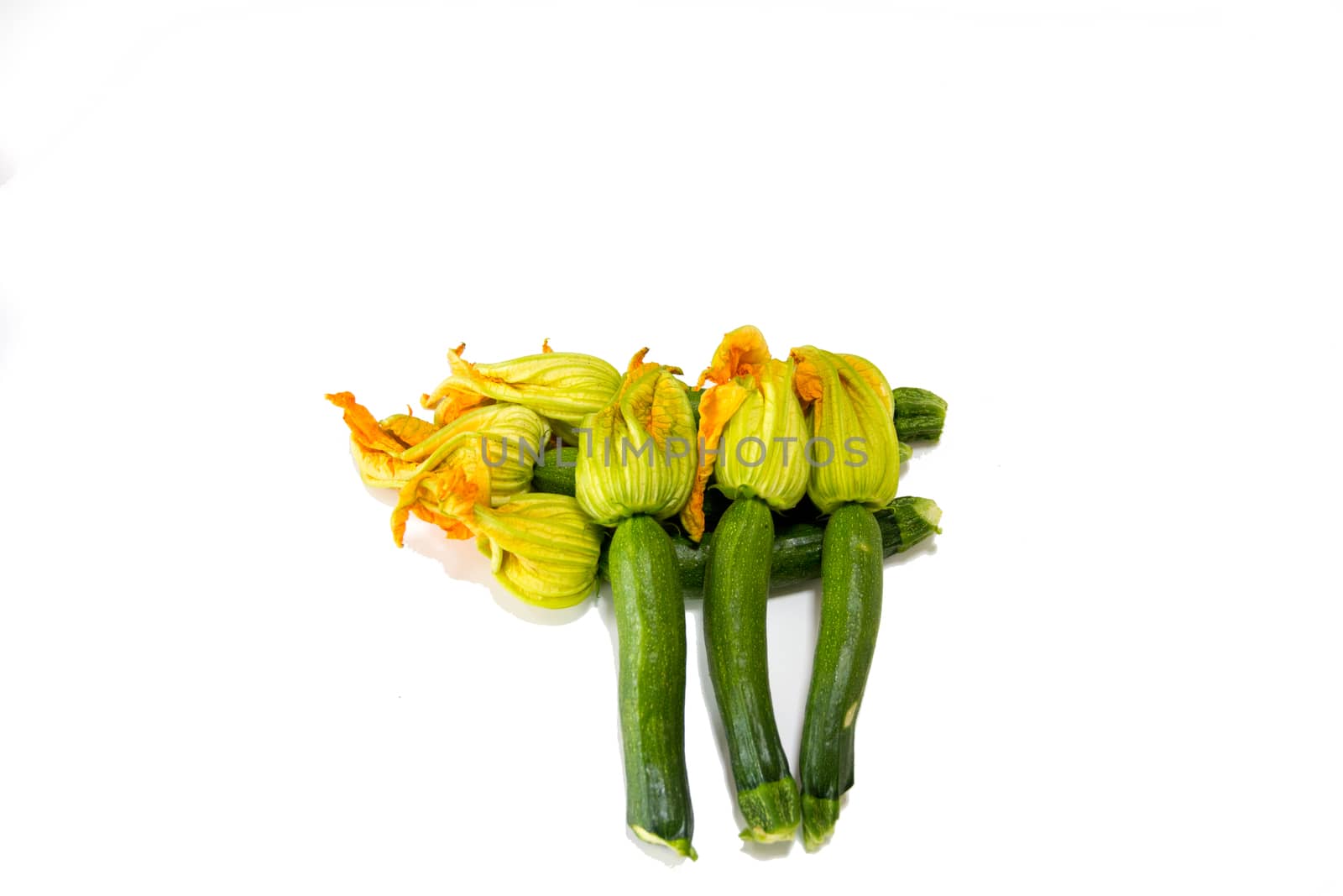 Arrangement of courgettes (zucchinis) on a white background