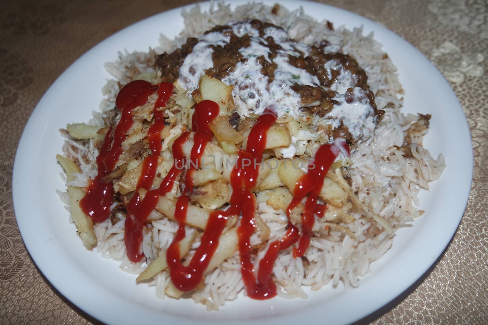 Delicious traditional dish of rice with potato fries and cereals with red ketchup. Food background with copy space for text and advertisements.
