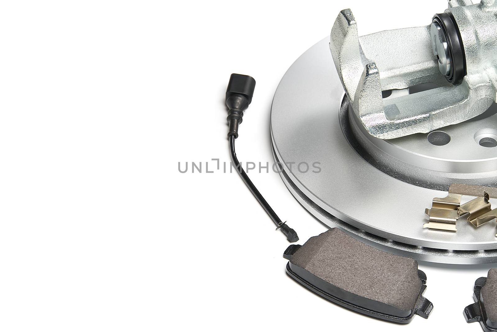 brand new brake discs, brake caliper and brake pad set for car. isolated on white with copy space