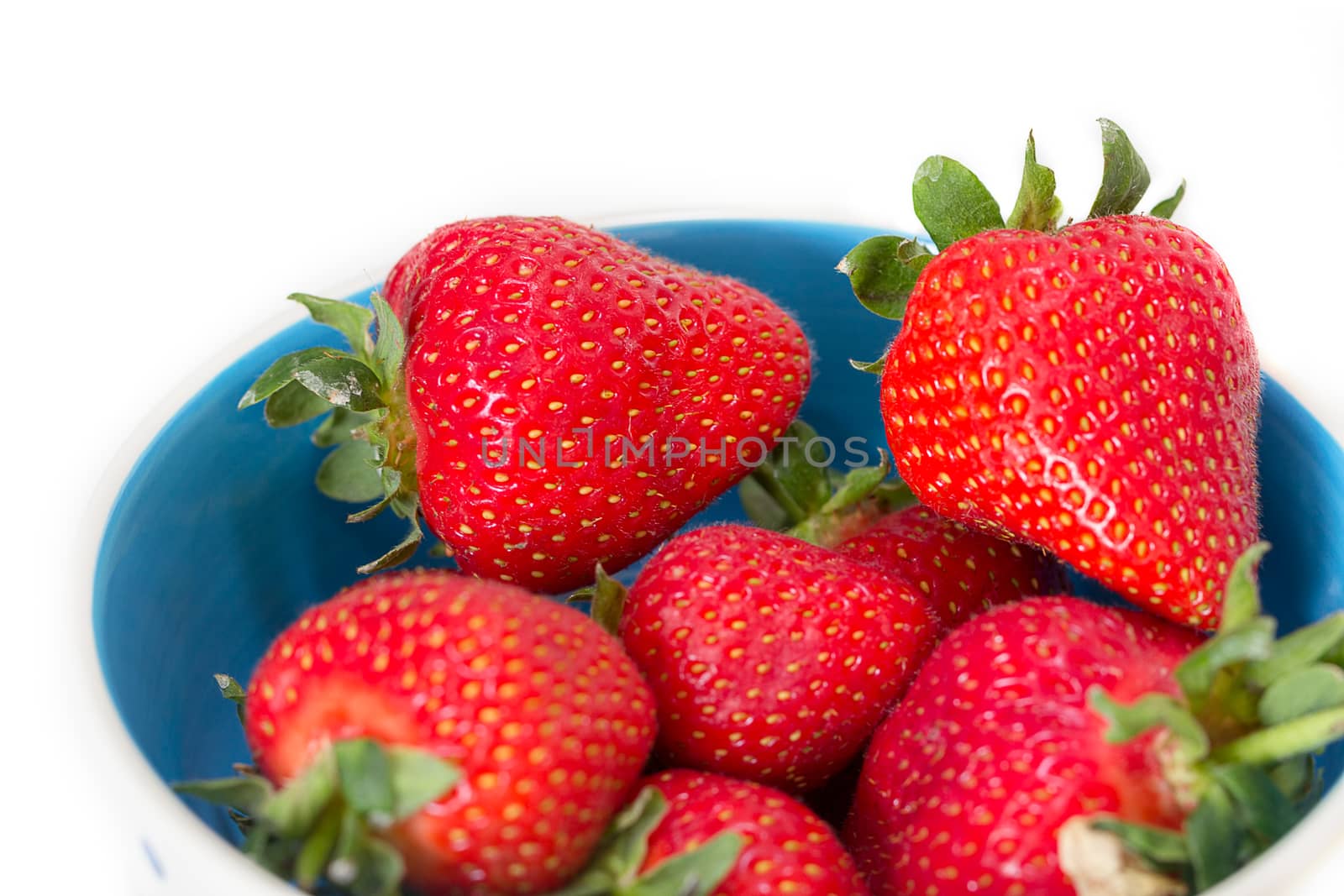 A bowl of juicy, ripe strawberries (Fragaria × ananassa) by magicbones