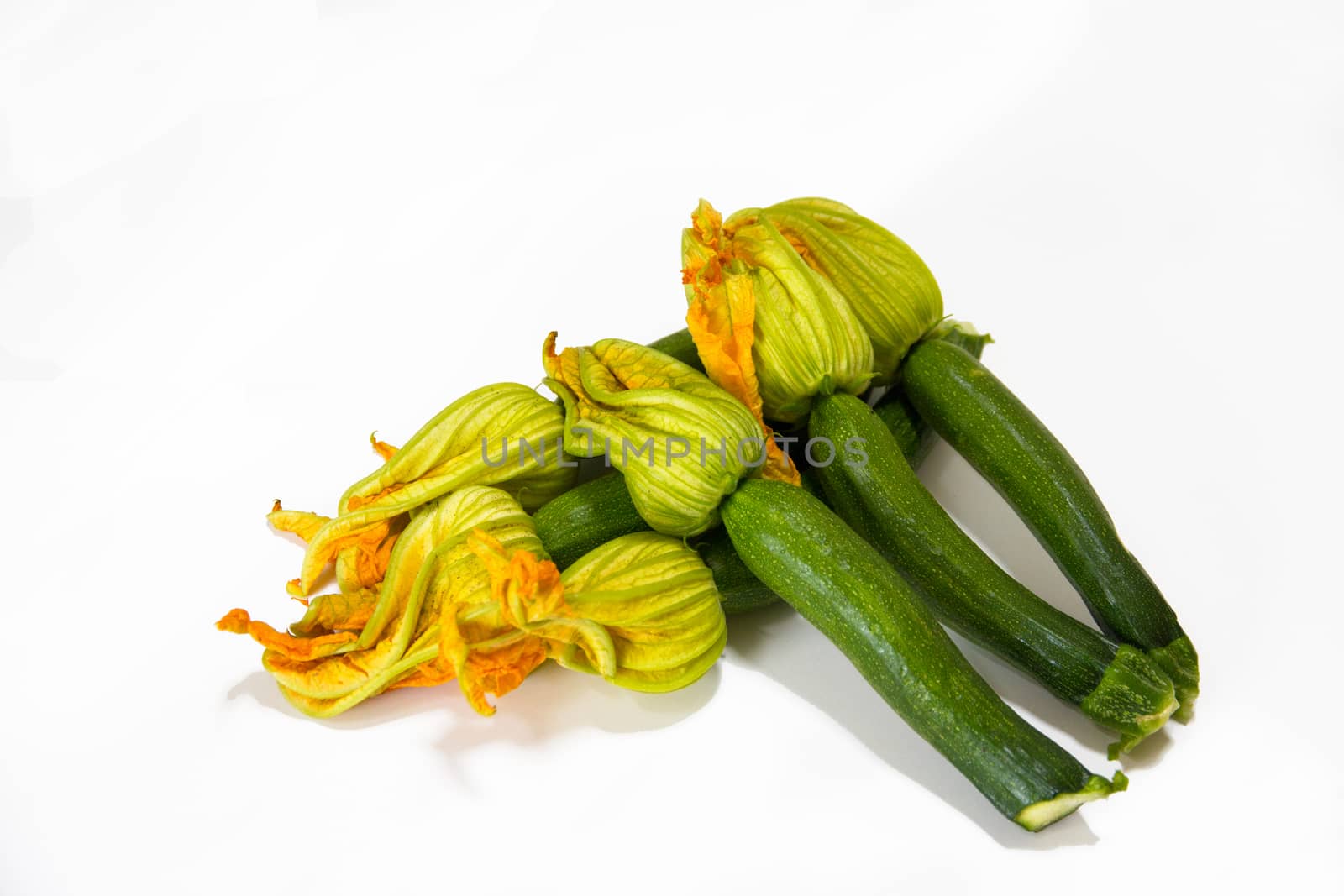 Arrangement of courgettes (zucchinis) on a white background