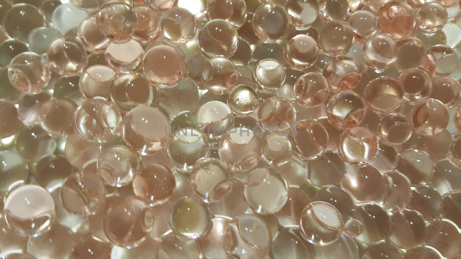 Closeup view with selective focus of shiny glittering orbeez or colorful water balls hydrogel. Water beads orbeez background.