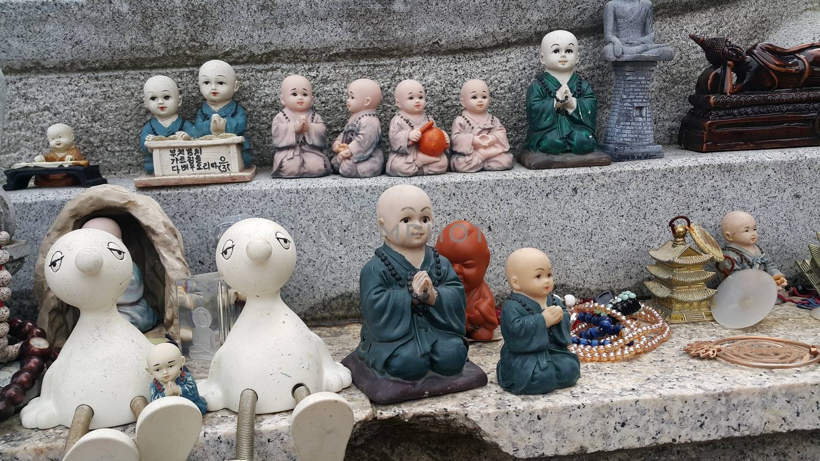 Closeup view of statues of religious monks. Buddha mini statue with beautiful background