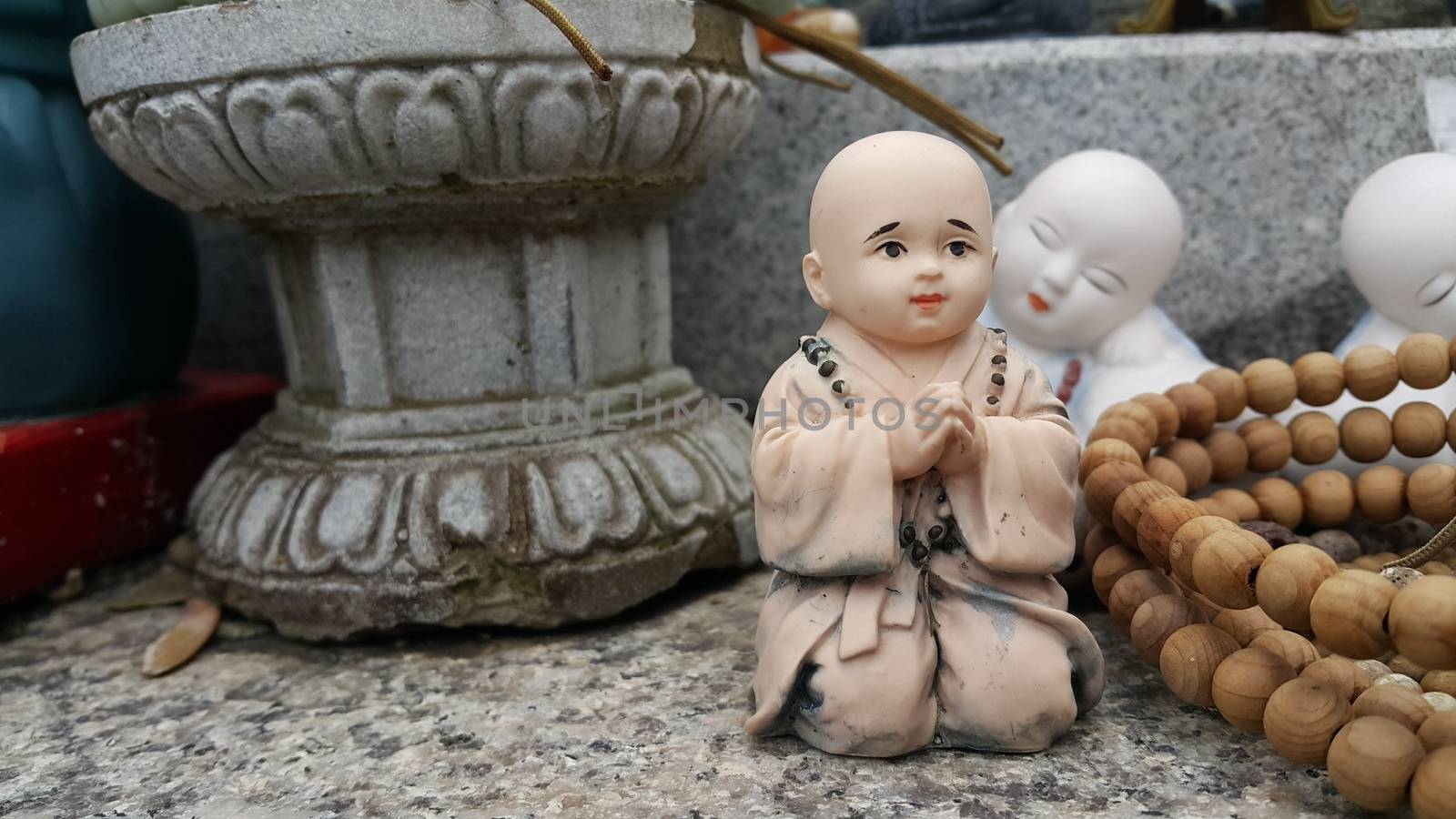 Closeup view of statues of religious monks. Buddha mini statue with beautiful background