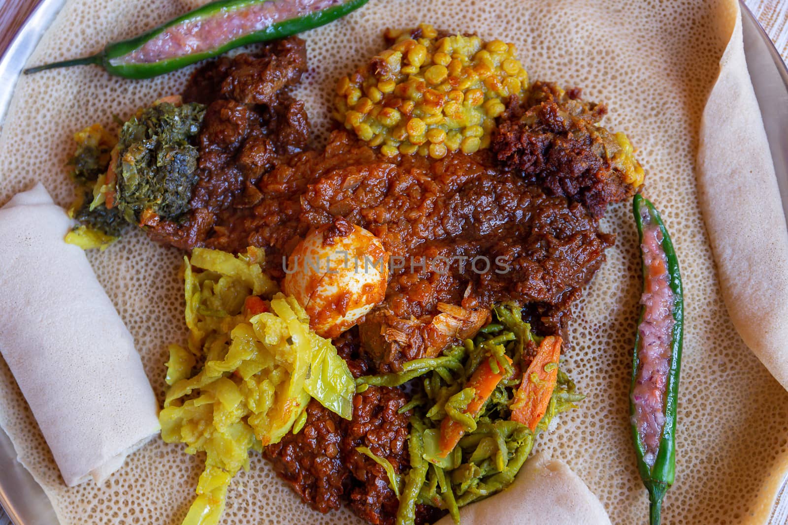 Injera with an assortment of toppings by magicbones