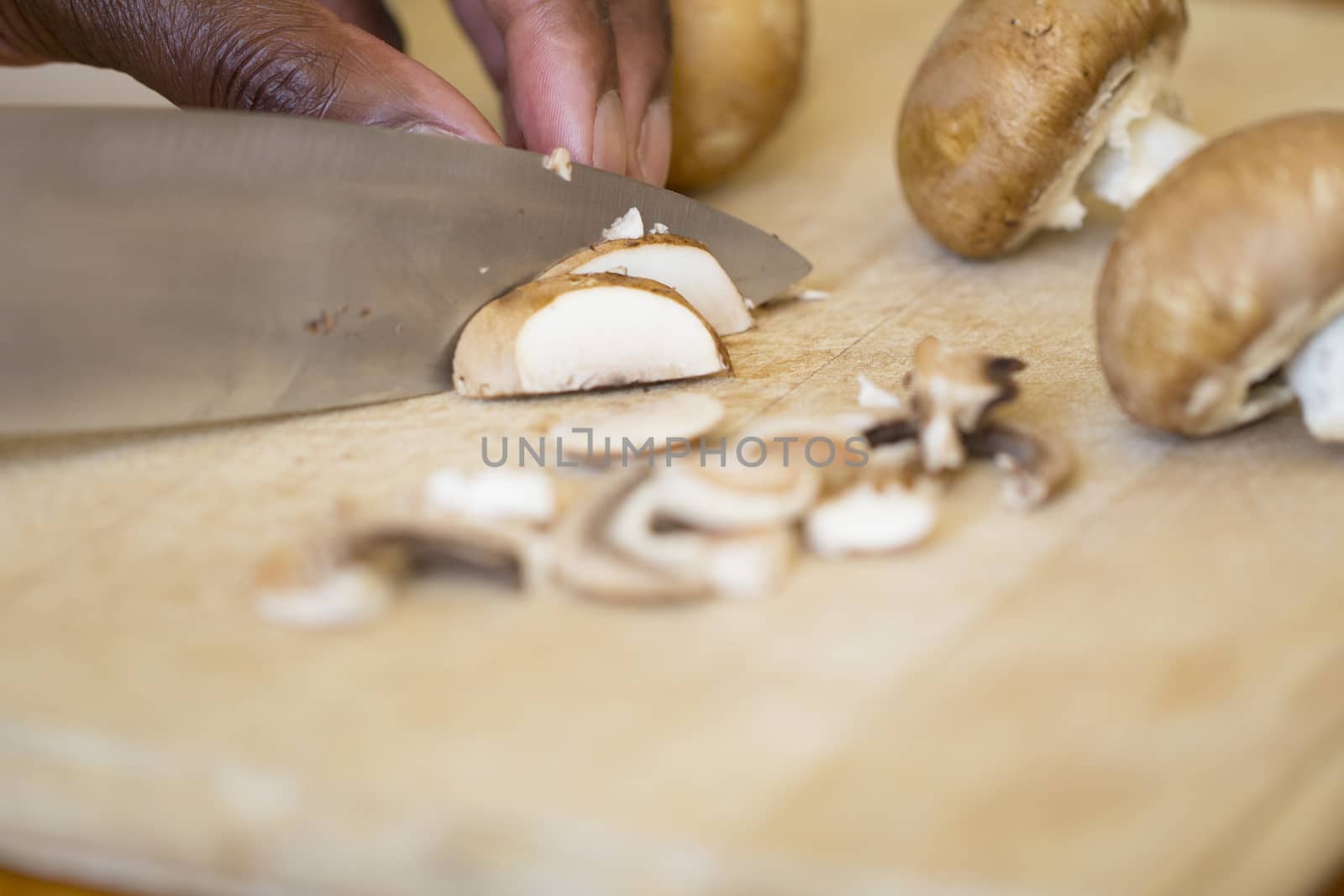 Black Man chopping Cremini mushrooms by magicbones